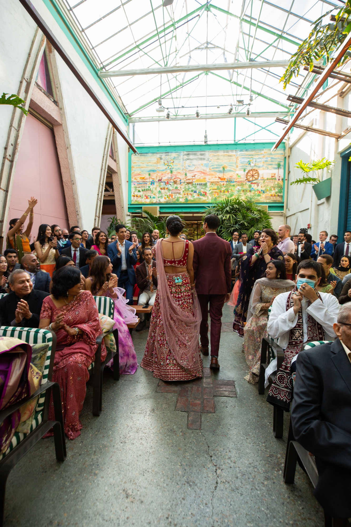 Indian newlyweds walk down the aisle to cheers
