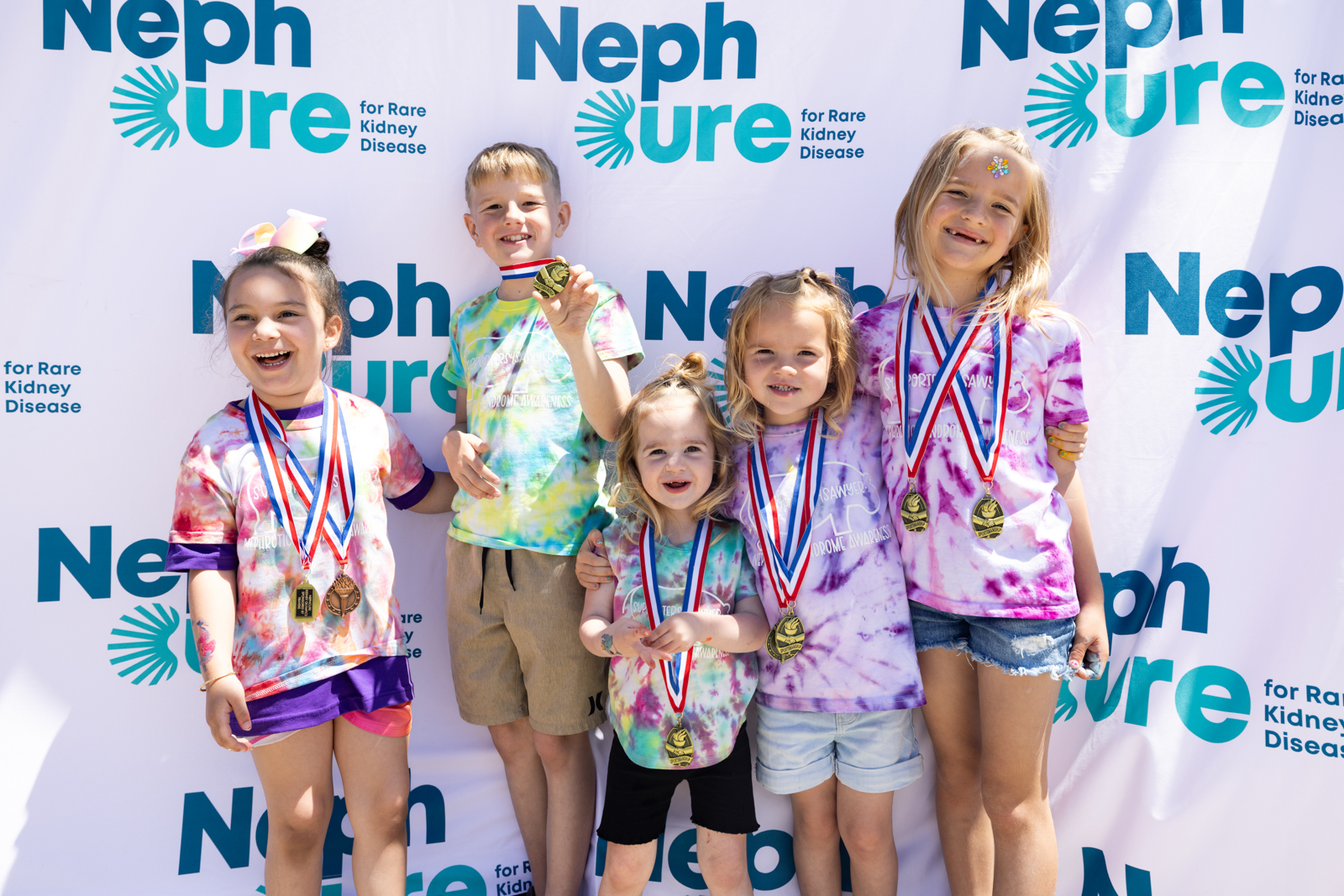 kids in front of step and repeat los angeles event