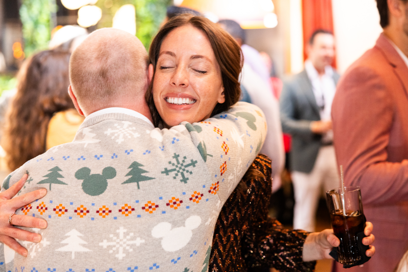 woman hugs coworker holiday party los angeles